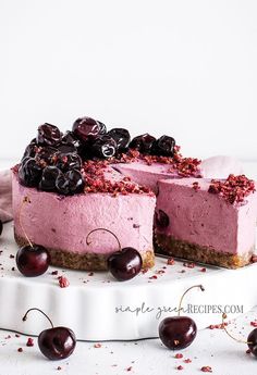 a cheesecake with cherries is on a plate