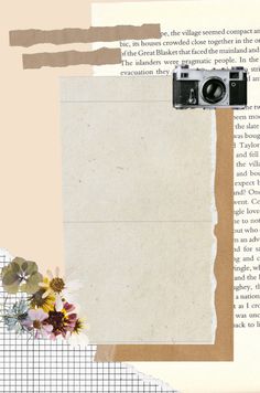 an old book with torn paper, flowers and a camera on the page next to it