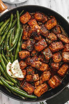 a pan filled with meat and green beans