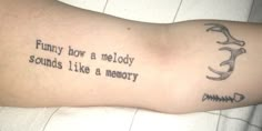 a tattoo saying funny how a melody sounds like a memory