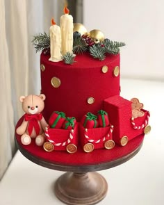 a red cake decorated with teddy bears and presents