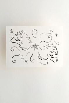 a piece of paper that has some writing on it with stars and swirls in the middle