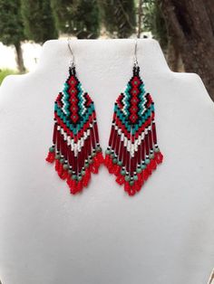 Beautiful Native American Style Beaded Rug Earrings in Black, White, Red and Turquoise. They are 4 inch long and 1 inch wide, with Twisted Red Glass Bugle Beads on them. If you like these but would like other Colors just email me.Thanks for looking. Red Southwestern Dangle Earrings, Southwestern Red Dangle Earrings, Artisan Red Beaded Earrings For Festival, Southwestern Style Red Dangle Earrings, Southwestern Red Beaded Dangling Earrings, Red Southwestern Style Earrings With Round Beads, Artisan Red Beaded Dangle Earrings, Southwestern Red Beaded Earrings With Dangling Beads, Red Southwestern Style Earrings For Festivals