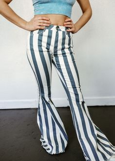 Indulge in the effortlessly chic style of our Serendipity Striped Flare Jeans! Made with a 34" inseam and a mid-rise fit, these multi stripe distressed denim pants add a western edge to any outfit. Super cute and true to size, they're sure to become your new go-to favorites! 75% COTTON 23%POLY 2%SPAN Spring Relaxed Fit Bottoms With Vertical Stripes, Chic Striped Bottoms For Spring, Spring Cotton Bottoms With Striped Hem, Fitted Bottoms With Striped Hem For Summer, Chic Striped Cotton Bottoms, Chic Stretch Bottoms With Vertical Stripes, Chic Fitted Bottoms With Striped Hem, Trendy Striped Bottoms For Spring, Trendy Striped Relaxed Fit Bottoms