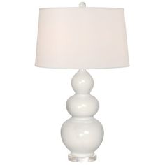 a white table lamp with a white shade on it