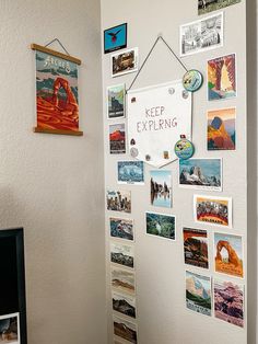 a white wall covered in pictures and magnets