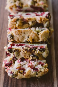 several slices of fruit and nut bars on a wooden table