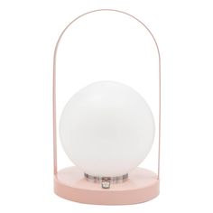 a white ball sitting on top of a pink stand