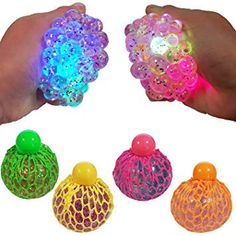 three different colored lights in the palm of someone's hand, one is holding an object