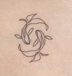 a small tattoo on the back of a woman's stomach, depicting a dolphin