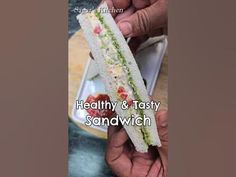 two hands holding a sandwich in front of a plate with salad on it and the words healthy & tasty sandwich