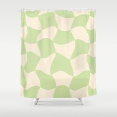 a green and white shower curtain with wavy shapes