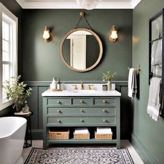 a bathroom with green walls and a white bathtub in the corner, along with a round mirror on the wall