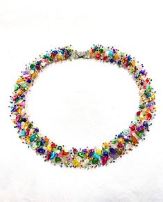 "This luxury rainbow necklace with small irregular Mother of Pearl / Shell beads was inspired by the bright flowering summer meadows. It is a bold and bright statement necklace for a confident lady and is bound to attract attention and make you stand out on any occasion. Natural Shell or MOP (Mother Of Pearl) is known as symbol of birth and good fortune. It is believed to stimulate intuition, imagination, sensitivity and adaptability.it is also one of the gemstones for June.  This necklace is made to size on a medium netted base from matching glass seed beads, embroidered in \"bead fur\" technique along with natural irregular MOP beads and glass seed beads. The necklace is about 1 inch wide and has approximately 40cm/50cm inner/outer diameter for a Small size, 45cm/55cm - for a Medium size Rainbow Necklace, Summer Necklace, Handcrafted Necklace, Shell Jewelry, Organza Gift Bags, Shell Beads, Shell Necklaces, Matching Bracelets, Matching Earrings