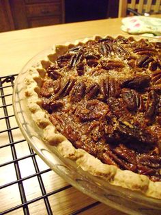 a pecan pie sitting on top of a cooling rack