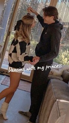 a man standing next to a woman in front of a glass door with the words dancing with my princess on it