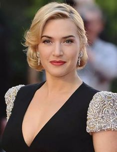 a woman with blonde hair wearing a black dress and diamond earrings on her head, posing for the camera