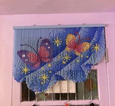 the window is decorated with beads and butterflies