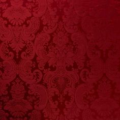 a red wallpaper with an intricate design on it's side and bottom corner