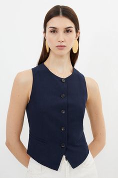 Waistcoats Are Reimagined To A Contemporary Level With This Piece. Crafted From Breathable Stretch Fabric, This Piece Is Tailored For A Sculpted Fit From A Collarless Round Neck To An Asymmetric Hem. Featuring Large Button Detailing Through The Front, Pair This Piece With Tailored Pants For A Considered-Edge Ensemble.Waistcoatsleevelessbutton Detailing Navy Waistcoat Outfit Women, Navy Waistcoat Outfit, Linen Waistcoat Woman Outfit, Waistcoat Styling, Navy Vest Outfit, Linen Waistcoat, Waistcoat Outfit, Wedding Pants, Transitional Fashion