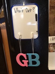 a refrigerator with magnets attached to it and the words who's out?