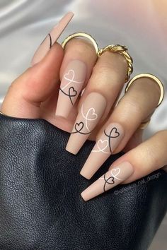 15 pretty and chic Valentine's nail ideas to try. We have rounded up lots of Valentine's Day nail ideas. From pink and red nails, to nails with heart designs we have you covered! Red nails, pink nails, heart nails, Valentines day nails, valentines day nails acrylic nail designs, nude nails, short trendy nails, pretty nails coffin, unique nail designs creative, chic nails, nails 2022, January nails, Febuary nails, nail ideas for valentines day, short valentines day nails. #valentinesnails Nails With Hearts, Cute Acrylic Nail Designs, Classy Acrylic Nails, Long Acrylic Nails Coffin