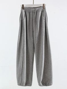 Elevate your comfort with our High-Waisted Sports Oversized Sweatpants. Made from a blend of cotton and polyester, they offer softness and durability. Their high waist and loose fit create a flattering and relaxed silhouette, while their solid pattern and flat front style exude casual elegance. With an elastic waist closure and functional pockets, they combine practicality with style. Perfect for leisure or workouts, these full-length sweatpants are a must-have addition to your wardrobe. Designe Oversized Gray Sweatpants With Pockets, Oversized Gray Sportswear Sweats, Gray Wide-leg Sweatpants For Loungewear, Gray Wide-leg Sweatpants For Streetwear, Gray High-waisted Sweatpants With Pockets, Oversized Sweatpants, Swimwear Shorts, Women's Wardrobe, Solid Pattern