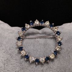 *Description: This is a beautiful Panetta dainty circular brooch with clear and dark blue rhinestones on a rhodium plated setting. The brooch is stamped PANETTA on the back on a raised cartouche. This would be a great addition to your vintage jewelry collection or make a great vintage gift! *Approximate Measurements: Length & Width - 1 3/16 Inches, Weight - .2 Ounce *Condition: Great vintage condition. Will see signs of wear under magnification. See photos for details. *Hallmark: Panetta *It Blue Round Brooch For Formal Occasions, Formal Blue Round Brooch, Formal Blue Round Brooches, Anniversary Rhinestone Round Brooches, Anniversary Round Rhinestones Brooches, Anniversary Round Brooches With Rhinestones, Anniversary Brooches With Rhinestones, Bird Brooch, Green Enamel