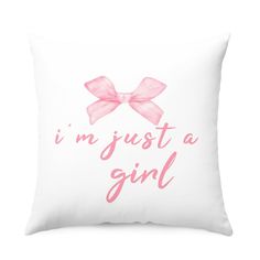 a pink pillow with the words i'm just a girl on it and a bow