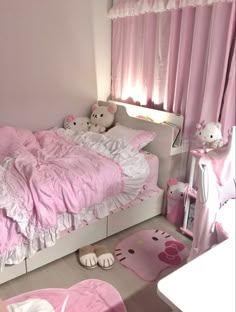 a pink bedroom with teddy bears on the bed and rugs in front of the window