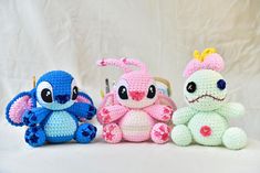 three crocheted stuffed animals sitting next to each other