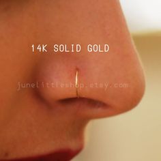 a nose piercing is shown with the words 4k solid gold on it's side