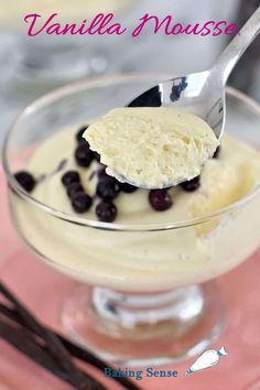 vanilla mousse with blueberries in a glass bowl on a pink place mat