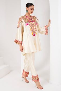 Ivory flared sleeves kurta with mirror, thread, tassel, sequin embroidered yoke. Paired with a salwar. - Aza Fashions Cream Kurta With Dabka Work, Beige Festive Traditional Wear, Traditional Long Sleeve Cream Sharara, Fitted Silk Beige Kurta, Beige Silk Fitted Kurta, Transitional Beige Traditional Wear, Traditional Wedding Sharara With Embroidered Sleeves, Traditional Fitted Sharara With Embroidered Sleeves, Fitted Silk Cream Kurta