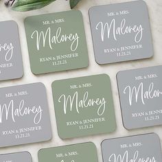 wedding coasters with names on them sitting next to a bouquet of tulips