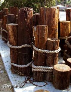 several wooden logs are stacked on top of each other and tied together with twine rope