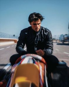 a man sitting on the back of a motorcycle