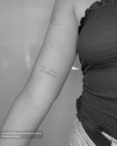 a woman with a small tattoo on her arm