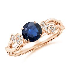 an oval blue sapphire and diamond ring in rose gold with diamonds around the band, on a white background