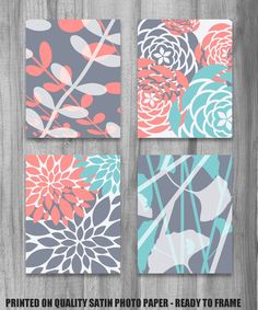 four square paintings with flowers on them in various colors and sizes, hanging on a wooden wall