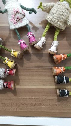 several knitted dolls sitting on top of a wooden table