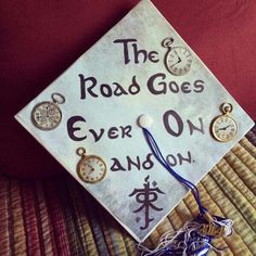 a white graduation cap with the words the road goes ever on andon