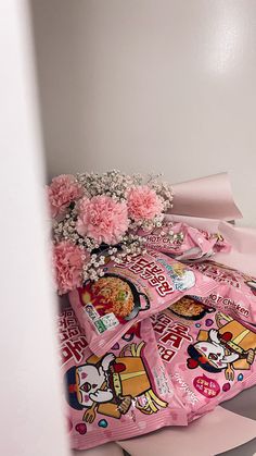 pink flowers and candy bags are on the floor