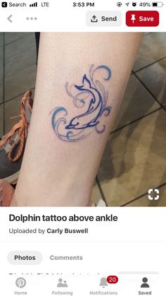 a tattoo on someone's leg that is blue and has the word dolphin tattoo above it