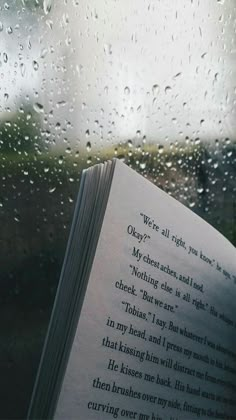 an open book sitting on top of a window next to raindrops and the words, we read to know what you are doing