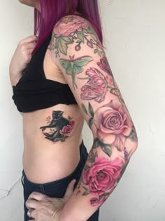 a woman with pink hair has tattoos on her stomach and arms, which are decorated with roses