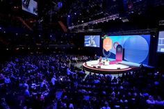 an audience is watching a speaker on stage