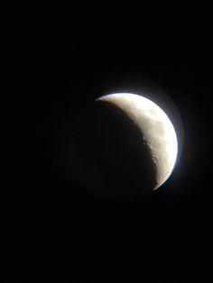 the moon is seen in the dark sky with its shadow on it's side