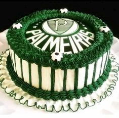 a green and white cake sitting on top of a table