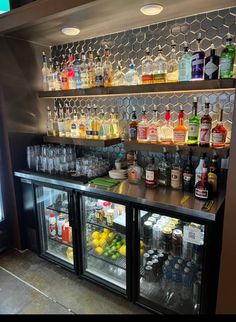 an image of a bar with drinks and liquors on the shelves for sale in a store